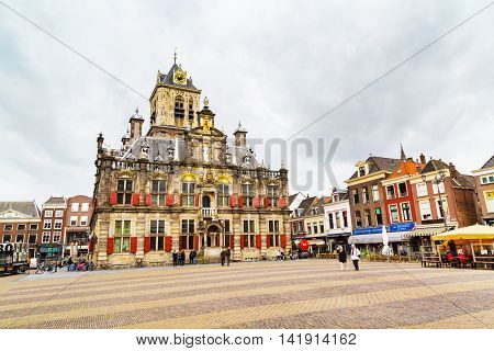 Delft, Netherlands - April 8, 2016: Stadhuis or City Hall, Markt square, houses and people in Delft, Holland