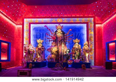 KOLKATA INDIA - OCTOBER 18 2015 : Night image of decorated Durga Puja pandal shot at colored light at Kolkata West Bengal India. Durga Puja is biggest religious festival of Hinduism.