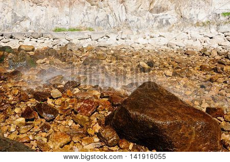 Water raining down from DaLong waterfall on to the rocks and boulders below within Yandang Town Yueqing County Zhezhiang province China.
