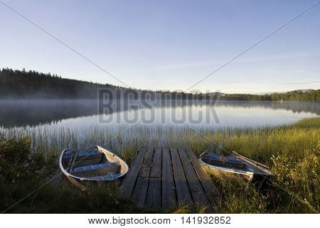 Moored boats in Lake Tevsjon near the Swedish village Ljusnedal early in the morning