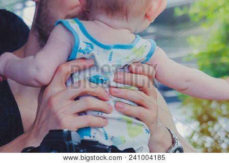 Close-up To Hands  Of Father Embracing And Kissing His Sweet Ado
