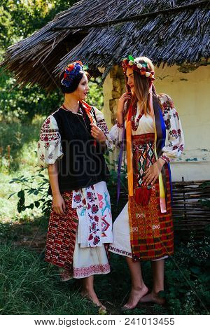 Two Beautiful Ukrainian Girl  Blond And Brunette In National Embroidered Clothes On A Background Of 