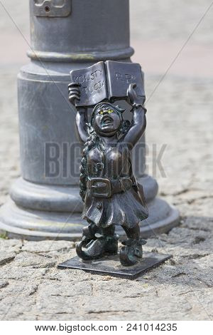 Wroclaw, Poland - April 15, 2017: Dwarf Women Symbol Of Democracy With The Polish Constitution In Ha