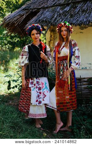 Two Beautiful Ukrainian Girl  Blond And Brunette In National Embroidered Clothes On A Background Of 