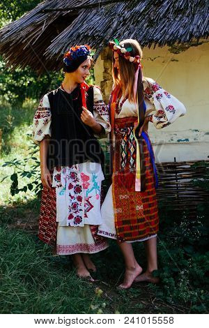 Two Beautiful Ukrainian Girl  Blond And Brunette In National Embroidered Clothes On A Background Of 