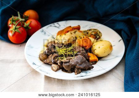 Beef meat stewed with potatoes-Traditional French cuisine Beef Bourguignon potatoes carrots in persillade