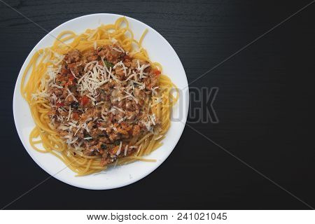 Appetizing Spaghetti In A Plate With Bolognese Sauce On A Dark Background Close Up And Copy Space