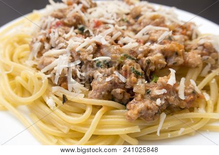 Appetizing Spaghetti In A Plate With Bolognese Sauce On A Dark Background Close Up