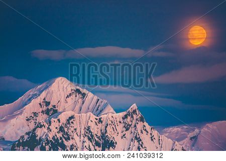 The beautiful Antarctic landscape the mountain snow-capped crest on the polar sunset sunrise background. Wild untouched nature was shot during the expedition to Vernadsky Research Base, Antarctica.