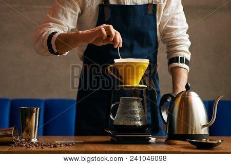 Professional Barista Or Coffee Barman Prepares Coffee By An Alternative Method Of Brewing, Pour Over