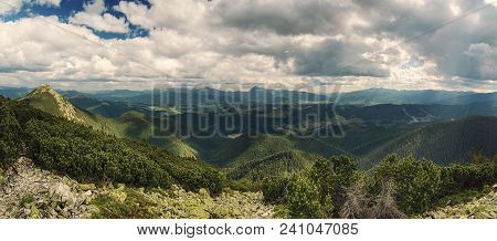 Carpathian Mountains Summer Landscape With Dramatic Clouds And Mossy Stones. Panoramic View