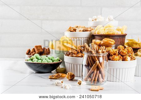 Variation Different Unhealthy Snacks Crackers, Sweet Salted Popcorn, Tortillas, Nuts, Straws, Bretse