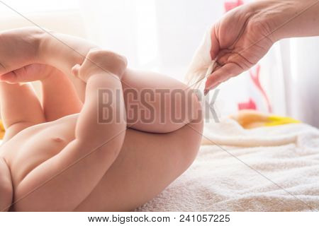 Hygiene - young momy wiping the baby skin with wet wipes. Cleaning wipe, pure, clean