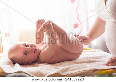 Hygiene - young momy wiping the baby skin with wet wipes. Cleaning wipe, pure, clean
