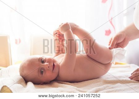 Hygiene - young momy wiping the baby skin with wet wipes. Cleaning wipe, pure, clean