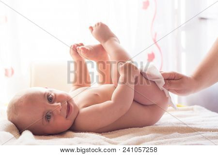 Hygiene - young momy wiping the baby skin with wet wipes. Cleaning wipe, pure, clean