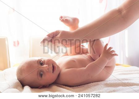 Hygiene - young momy wiping the baby skin with wet wipes. Cleaning wipe, pure, clean