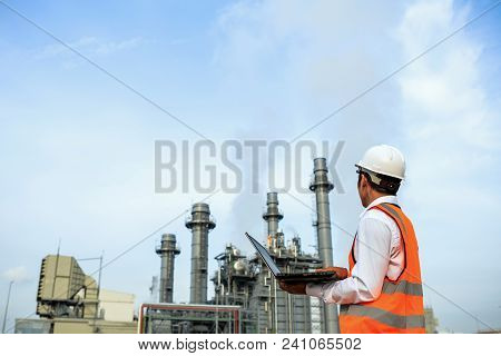Engineer In Uniform And Helmet On Of Background The Construction Site Power Plant.
