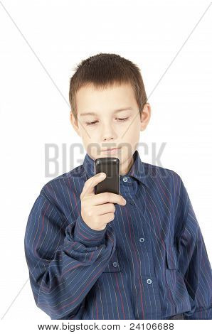 The Boy Looks At A Mobile Phone