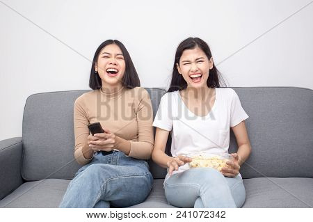 Aisan Woman Wacthing Television With Happy Emotion. People Lifestyle Concept.