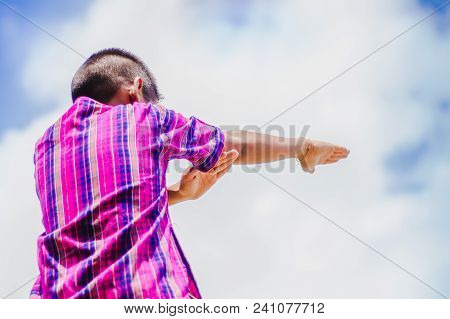 Student Acting Like A Superhero On Top Of Stepladder In School.