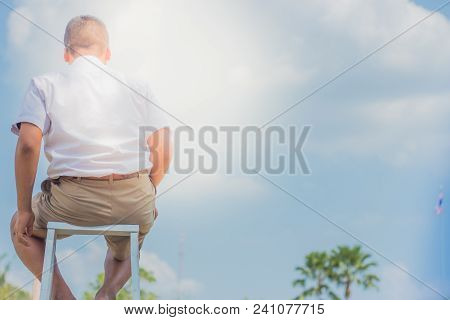 Student Acting Like A Superhero On Top Of Stepladder In School.