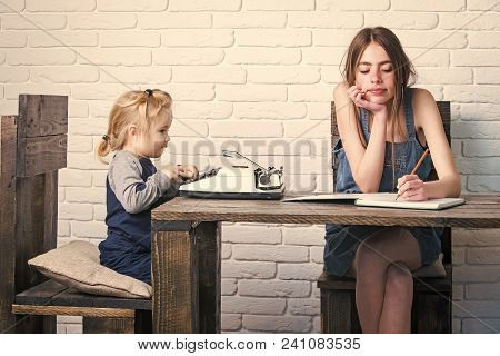 Kids Enyoj Happy Day. Girl And Child Sitting At Table. Young Woman Writing In Notebook. Kid Typing O
