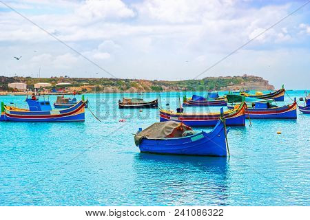 Luzzu Colorful Boats At Marsaxlokk Port In The Bay Of The Mediterranean Sea, Malta Island