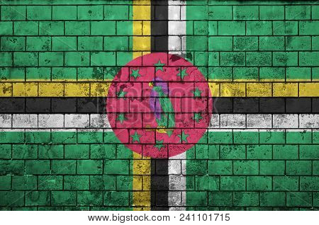 Dominica Flag Is Painted Onto An Old Brick Wall