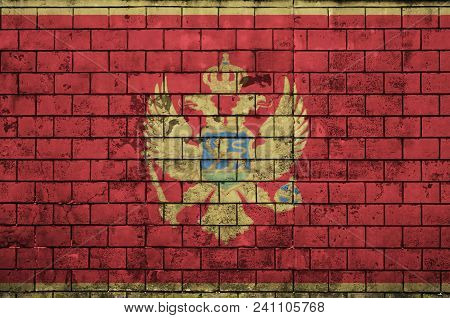 Montenegro Flag Is Painted Onto An Old Brick Wall