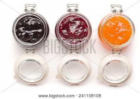 Tasty fruity jam in jar isolated on white background.