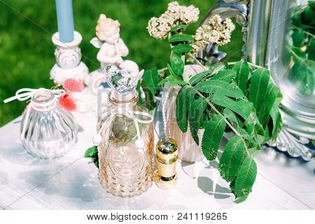 Decorated Console Mirror With Candles, Perfume Bottles And Other Makeup