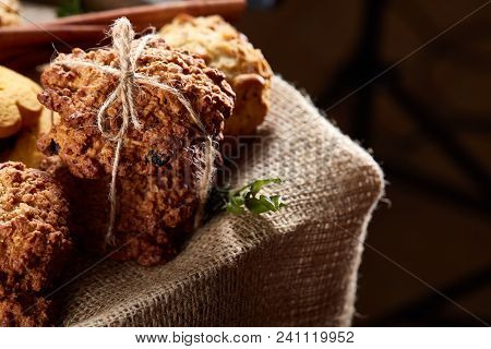 Conceptual Composition With Assortment Of Cookies, Cinnamon Sticks Bunch On A Wooden Barrel Over Rus