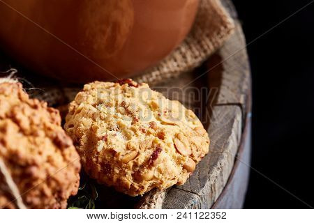 Conceptual Festive Composition With A Cup Of Hot Tea, A Large Set Of Cookies, Cinnamon Sticks Bunch 
