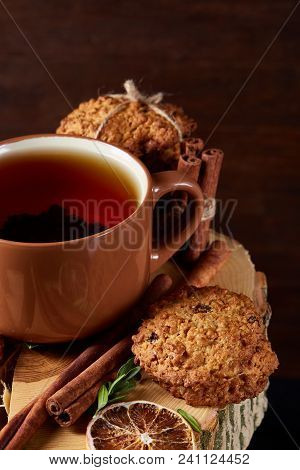 Christmas Concept With A Cup Of Hot Tea, A Large Set Of Cookies, Cinnamon Sticks Bunch, A Couple Of 