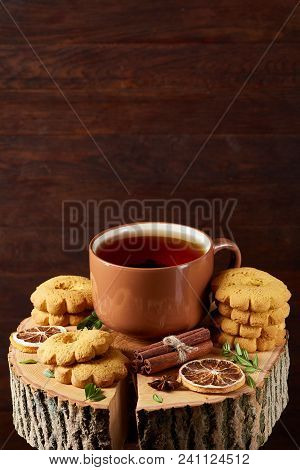 Christmas Concept With A Cup Of Hot Tea, A Large Set Of Cookies, Cinnamon Sticks Bunch, A Couple Of 