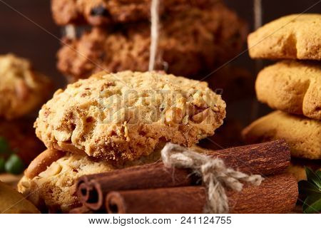 Christmas Concept With Asoortment Of Delicious Sweet Cookies, Cinnamon Sticks Bunch, A Couple Of Dri