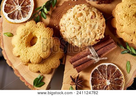 Christmas Concept With Asoortment Of Delicious Sweet Cookies, Cinnamon Sticks Bunch, A Couple Of Dri