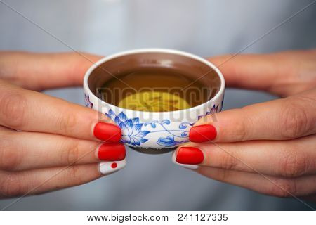 Cropped Shot Of Woman Holding Chawan With Green Oolong.