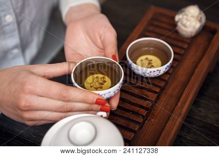 Cropped Shot Of Woman Holding Chawan With Green Oolong.