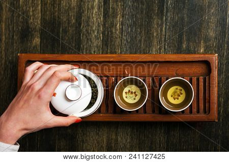 Cropped Shot Of Woman Holding Chawan With Green Oolong.