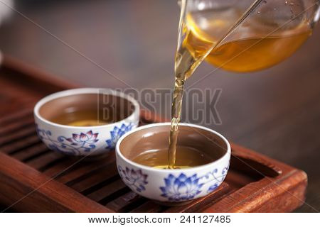 Cropped Shot Of Woman Holding Chawan With Green Oolong.