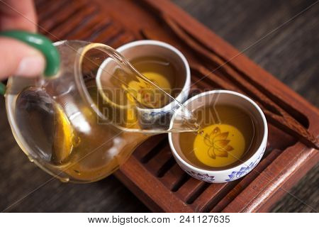 Cropped Shot Of Woman Holding Chawan With Green Oolong.