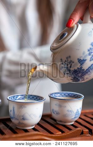 Cropped Shot Of Woman Holding Chawan With Green Oolong.
