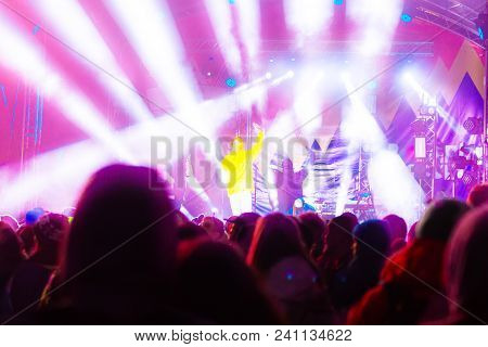 Silhouettes Of Concert Crowd In Front Of Bright Stage Lights