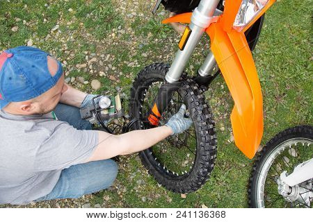 Man Motorcycle Tire Manual Air Pressure Testing Before Traveling Trip For Safety Riding Vehicle