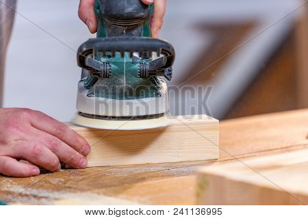 Working With Sanding Wood Bars Rotary Machine For Grinding On A Workbench In Motion