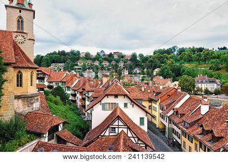 Bern, Switzerland - August 31, 2016: Nydegg Church And Old Houses Rooftops Of Bern, Switzerland. See