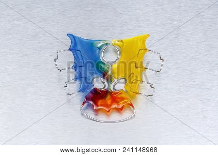 Colorful Dental Braces Or Retainer For Teeth On Metall Background, Closeup