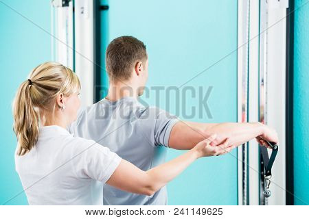 Patient at the physiotherapy doing physical exercises with Bowden cable 